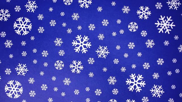 Rotating White Snowflakes on Blue Background Motion Video Footage