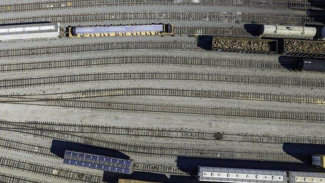 Aerial view of CSX's Radnor Yard and Nashville Intermodal train terminal with various freight train cars on multiple parallel tracks in Nashville, TN, United States.