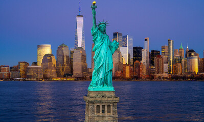 Manhattan skyline Freedom Tower and Liberty Statue. New York City skyline with the Statue of Liberty over Hudson River. Manhattan at dusk with Statue of Liberty. NYC landmark with Statue of Liberty. © Volodymyr