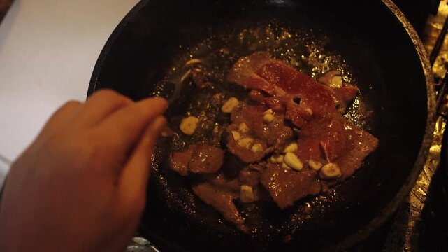 Cooking Beef Steak Slices with Garlic in Frying Pan Video