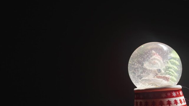 Christmas Snow Globe on Dark Background with Copy Space Video