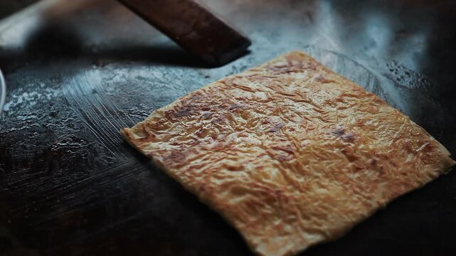Traditional flatbread cooking on a hot griddle