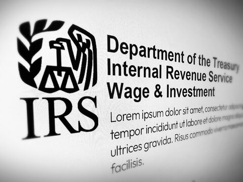 Close up of IRS logo and text on screen, Department of the Treasury Internal Revenue Service, wage and investment, illustrative editorial
