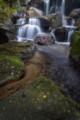Waterfall cascade and boulders in forest © Kelly