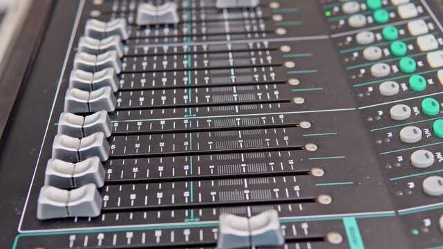 Motorized faders moving on digital audio mixing console