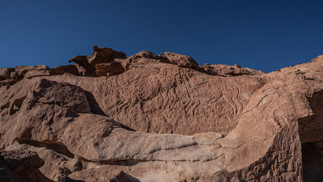 Pre-Hispanic archaeological site with ancient rock art in Rainbow Valley, Atacama Desert.