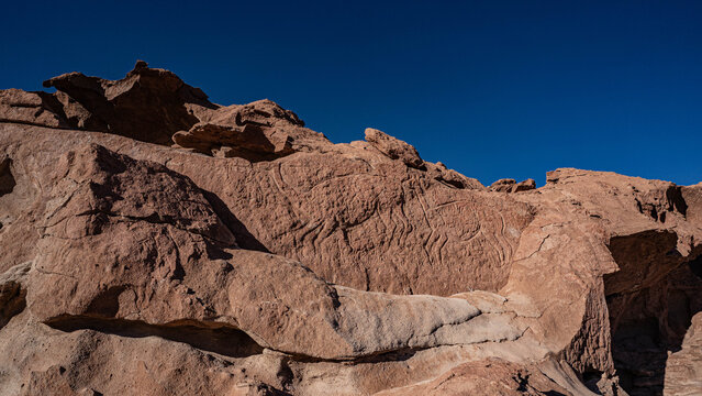 Pre-Hispanic archaeological site with ancient rock art in Rainbow Valley, Atacama Desert.