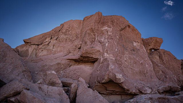 Ancient pre-Columbian petroglyphs carved on rock in the Atacama Desert, Chile.
