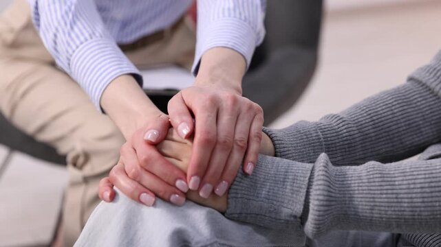 Mental health. Psychologist supporting woman during therapy session indoors, closeup