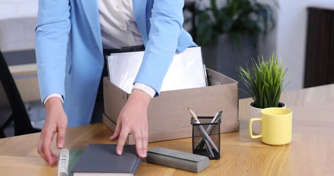 Woman packing her things after being fired, closeup. Concept of unemployment