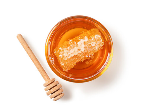 Golden Honey with Honeycomb and Wooden Dipper on White Background. Top view