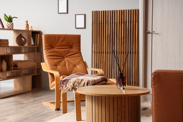 Interior design and home comfort, cozy living room with leather armchair and wooden furniture for relaxation and lifestyle wellness in modern apartment © Pixel-Shot