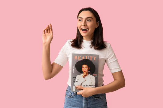 Beauty and fashion trends, excited young woman holding a lifestyle magazine with style tips and outfit ideas on a solid pink background