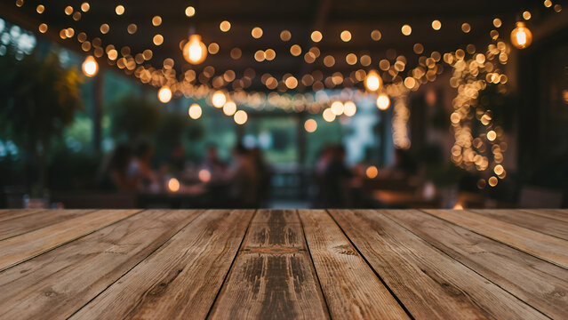 Empty rustic wooden table top with blurred restaurant patio background with warm string lights for product display or food presentation