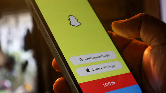 Social media login screen with continue with google and apple buttons on smartphone.