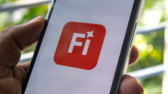 Figma app icon with a white "Fi" and star on a red square background on a smartphone.