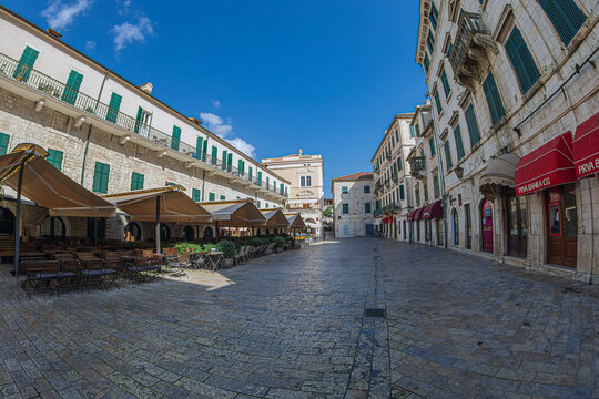 Kotor, Montenegro - Sept 1, 2026: Arms Square (Trg od oružja) in the Old Town, a historic pedestrian space lined with caf&eacute; terraces and Venetian-style architecture.