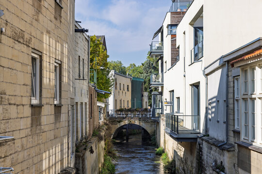 Valkenburg, Netherlands, October 04, 2026. The Kleine Geul river canal winding between historic marlstone buildings and modern apartments.