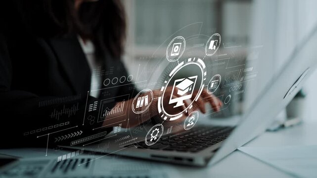 Modern Professional Working on Laptop with Digital Education Symbols and Technology Graphics in Bright Office Environment. Entropy.