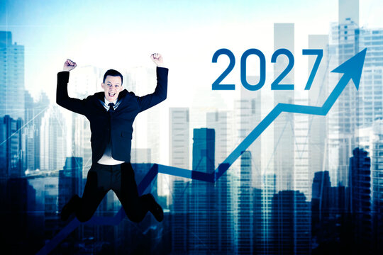 Excited Businessman Jumping with 2027 Growth Chart Over City Skyline