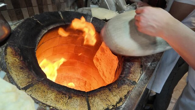 Baking bread in a traditional oven in a busy kitchen