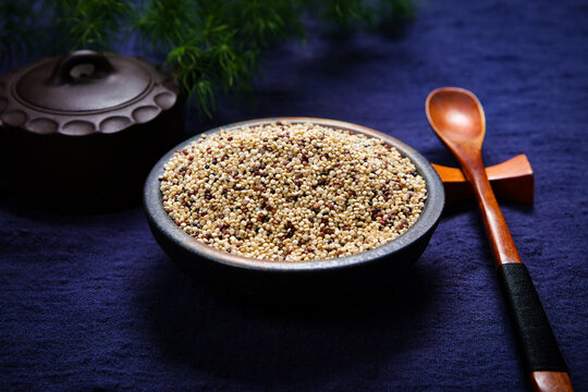 Mixed tri-color quinoa grains in blue ceramic plate