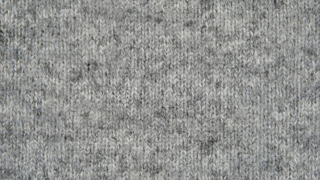 Grey felt fabric texture background, soft mottled wool textile surface, industrial gray non-woven material for craft and design
