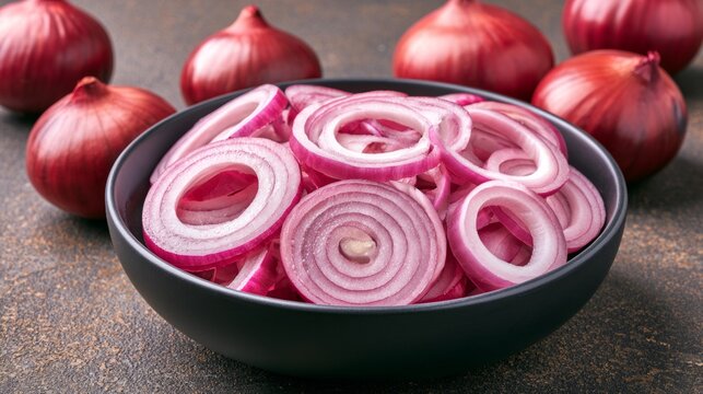Freshly Sliced Red Onions in Bowl with Whole Onions in Background for Culinary Presentation