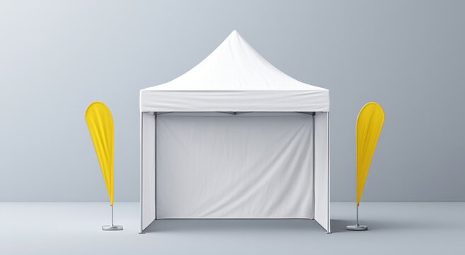 White pop up tent with yellow feather flags stands on a gray backdrop