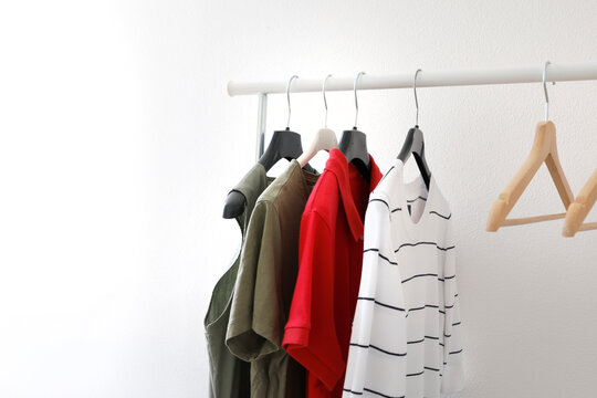 Empty white wall mockup with clothes rack space for design display. Minimalist interior copy space neutral background texture. Poster print artwork presentation branding.