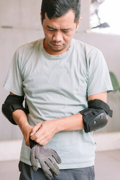 Man Preparing Protective Gear for Inline Skating or Rollerblading