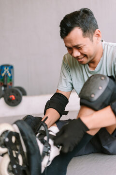 Man Preparing to Inline Skate Wearing Protective Gear Outdoors