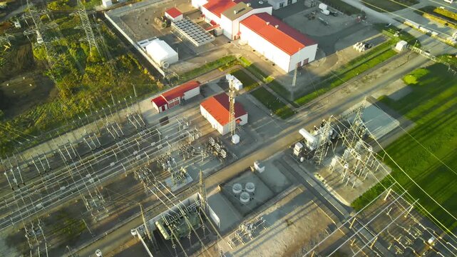 High voltage electrical substation with transformers and power lines supplying energy to a large, modern data center, showcasing the critical infrastructure for digital technology and communication