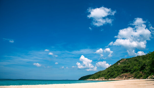 Summer tropical beach white sand blue sea summertime on sunny day. Sea coast beach scenery foamy wave on the beach waves of blue sea tropical ocean sand. Travel holidays vacation seaside turquoise