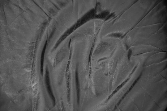Full frame close-up view of the surface of a black leather couch