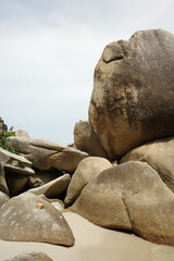 Giant rounded granite boulders on a sandy beach © Cavan