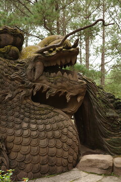 Giant stone dragon sculpture in the woods