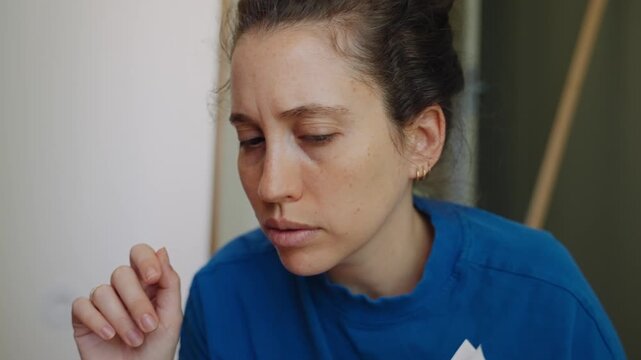 Frustrated and puzzled young woman reading a complicated do it yourself manual for assembling new furniture. Looking tired and confused by the difficult instructions during a home improvement project