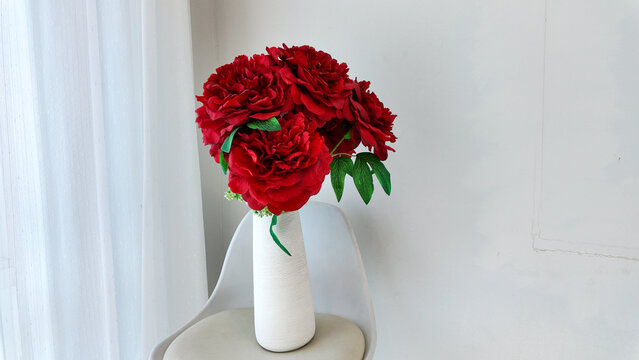 Elegant Arrangement of Lush Red Flowers in Modern Vase Interior