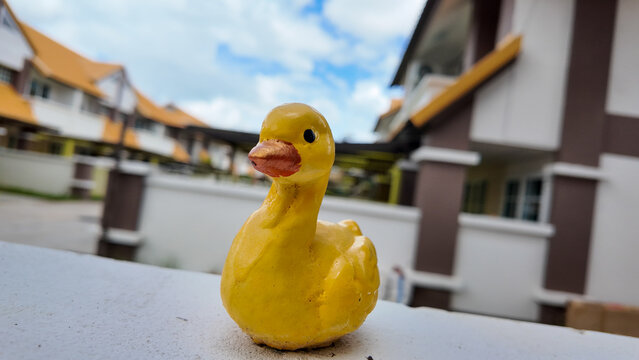 Yellow Rubber Duck Toy with Skyline Background at Residential Area