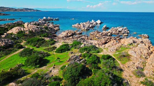 Drone view near Spiaggia Testa del Polpo in Sardinia. Rugged granite rocks, blue sea and natural coastline create a dramatic La Maddalena seascape.