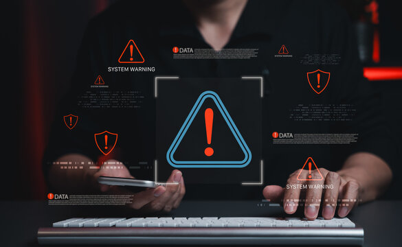 Cybersecurity warning and data threat detection concept. Person using computer with alert icons, system warning messages and danger symbols, cyber risk, network protection, digital security monitoring