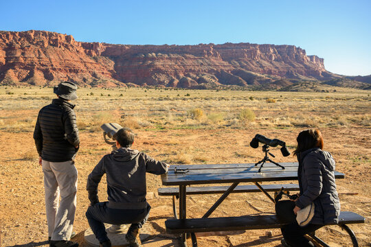 Visitors watching wildlife through binoculars and a spotting scope at the Condor Viewing site. Vermilion Cliffs National Monument. Arizona. USA.