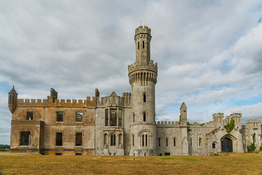 The majestic ruins of an old Irish castle under a cloudy sky
