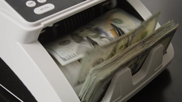 Money counting process. Paper money in counting machine. Business and finance concept with money. UDS in motion. Counting paper money bills. Banking and cash concept. Savings dollars theme.