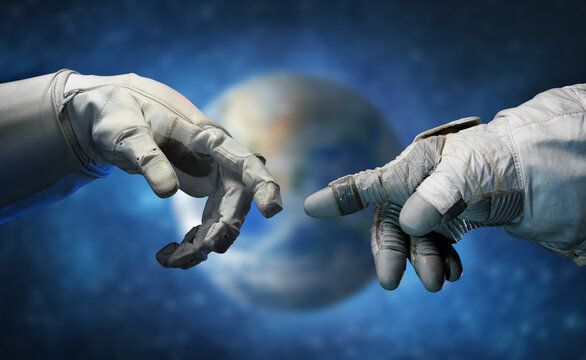 Astronaut hands and on outer space background. Elements of this image furnished by NASA.