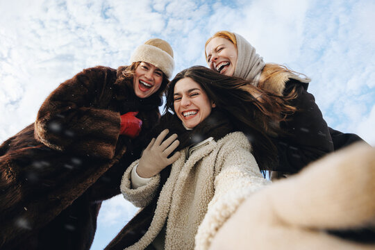 Snowy women take a selfie under a blue sky
