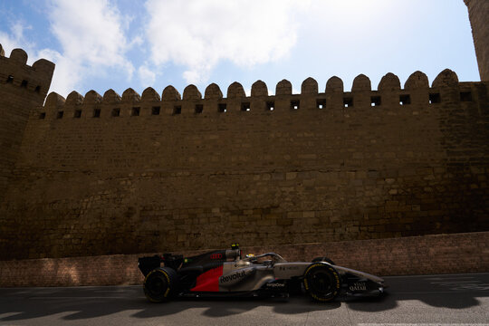 BAKU, AZERBAIJAN - SEPTEMBER 2026: Audi Revolut F1 Team car speeds alongside the ancient Old City fortress wall during the Azerbaijan Grand Prix