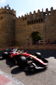 BAKU, AZERBAIJAN - SEPTEMBER 2026: Scuderia Ferrari F1 Team car speeds past the ancient Old City fortress wall during the Azerbaijan Grand Prix