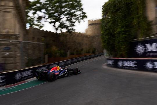 BAKU, AZERBAIJAN - SEPTEMBER 2026: Oracle Red Bull Racing F1 car speeds along the Baku City Circuit near the historic Old City castle wall during the Grand Prix